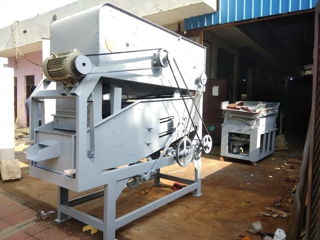 Gravity destoner machine with belt drive standing outside the workshop