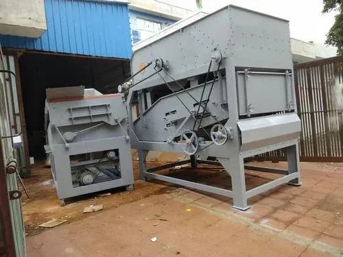 Seed cleaner and gravity separator standing side by side in a yard